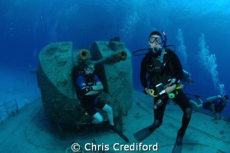 My dive buddy, Andy, chilling in the background on the Ca... by Chris Crediford 