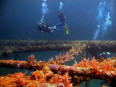 Divers at decommissioned Oil Rig made to artificial reefs. by Ng Steven 