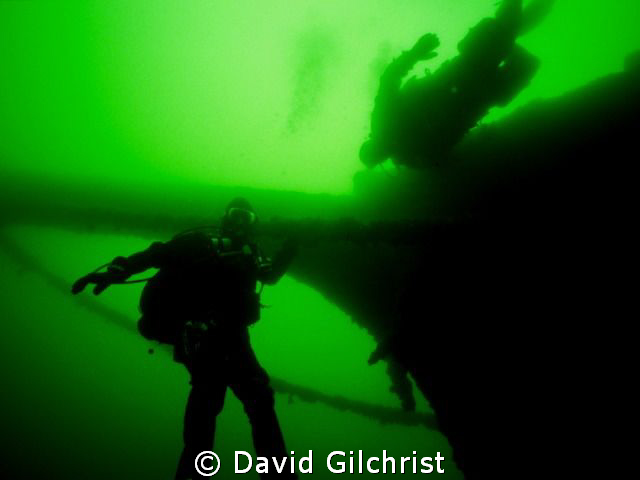 Divers at the bow of Great Lakes sailing vessel- George A... by David Gilchrist 