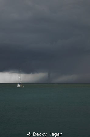 A larger water spout makes its way towards our boat in th... by Becky Kagan 