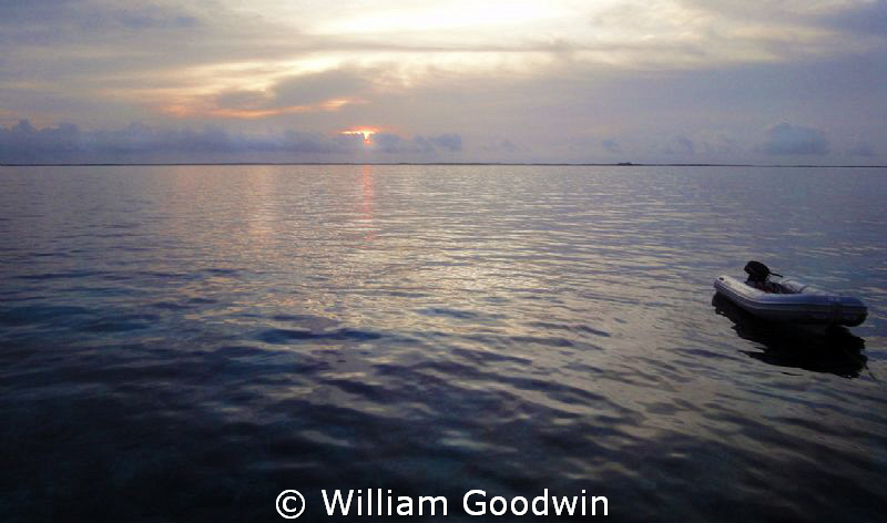 Sunrise from the Sun Dancer off Terneffe Atoll. by William Goodwin 