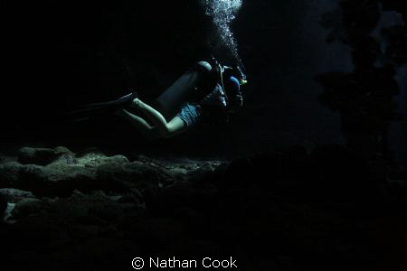 A diver in a swim through on Iron Shore Gardens, Grand Ca... by Nathan Cook 