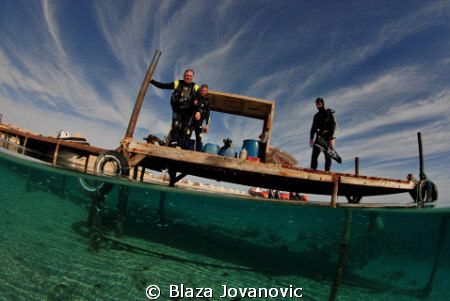 A group of divers on the jetty of Marsa Shagra Eco Villag... by Blaza Jovanovic 