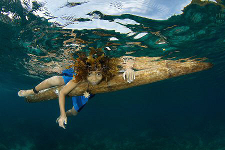 This is JenJen, a happy kid from Apo Island paddling arou... by Steve De Neef 