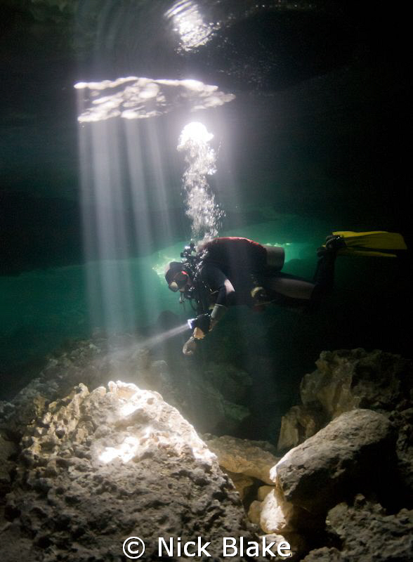 "Into the Light".
Diver in sunbeams in Taj Maha Cenote, ... by Nick Blake 