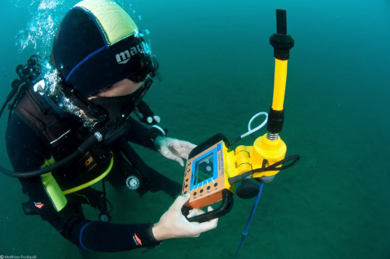 marine biologist working with a underwater acoustic telem... by Mathieu Foulquié 
