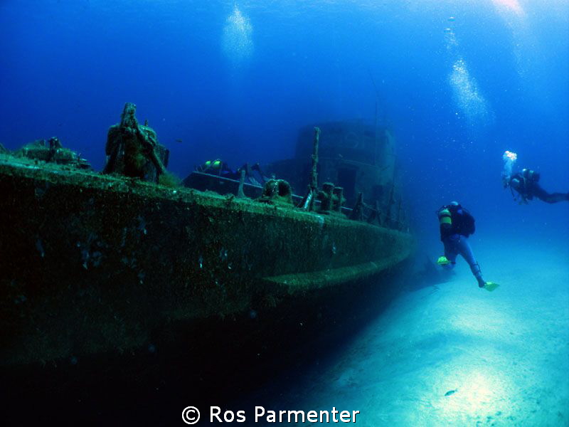 Divers approaching the wreck of the P31 off Comino Island by Ros Parmenter 