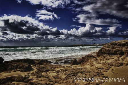 Sands, rocks, sea and sky with clouds. by Francesco Pacienza 