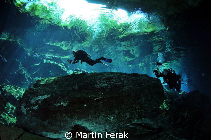 Divers in cenote by Martin Ferak 