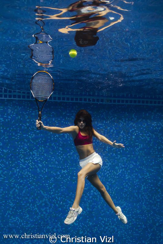 Woman playing tennis underwater, just for fun!! by Christian Vizl 