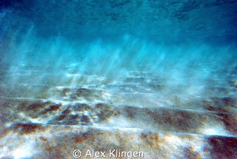 Sand breaking loose off the bottom due to wave action II. by Alex Klingen 