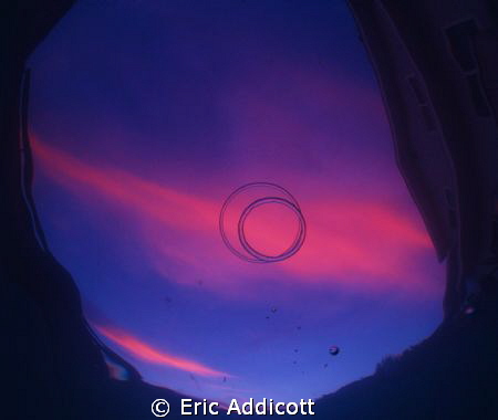 Sunset with bubble rings from the bottom of my pool. by Eric Addicott 