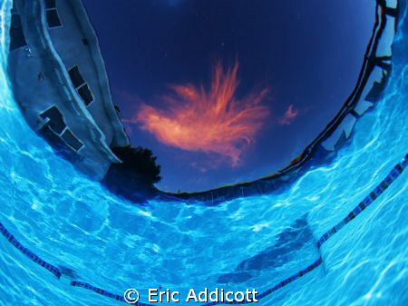 Sunset from the bottom of the pool...just one cloud up th... by Eric Addicott 