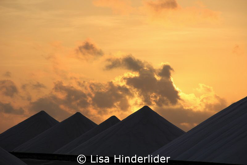 Morning sun rising behind the salt piles- Bonaire by Lisa Hinderlider 