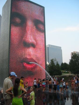 kids cooling off on a hot summer day at millenium park, c... by Lisa Lappe 