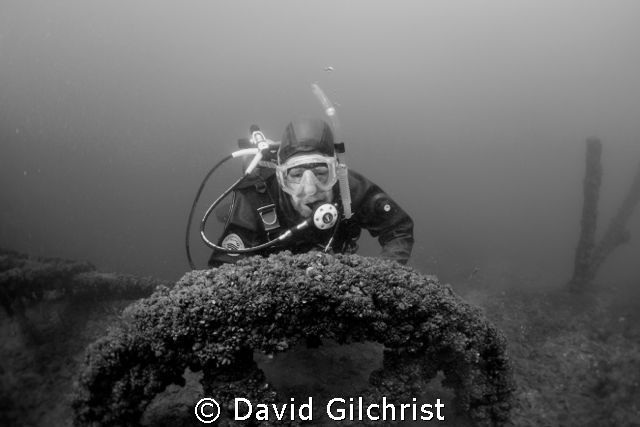 Diver poses at the fly wheel of pump in Sherkston Quarry. by David Gilchrist 