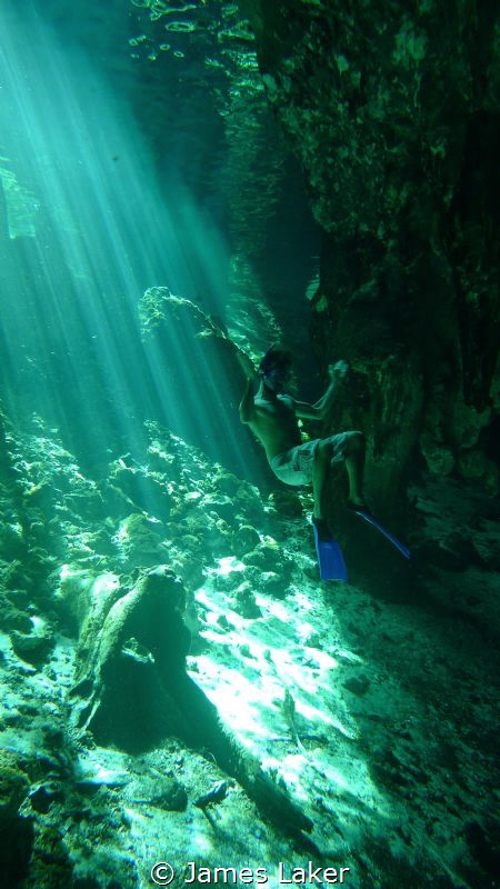 Ambient light photo of snorkeller in Grand Cenote near th... by James Laker 