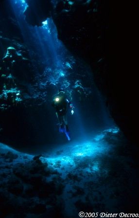 Diver in sunrays ina cave by Dieter Decroos 