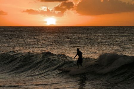 Surfing at sunset @ Turtle Bay Oahu by Glenn Poulain 