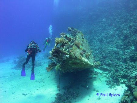 Photographer and wreck of a yacht, Red Sea by Paul Spiers 