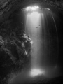 This image was taken at 'The Pit Cenote' in Tulum, Mexico. Freedivers were practicing as I took the image. One waiting on a rock while the other diver ascends. The hydrogen sulfate layer can be seen below at 90ft. 