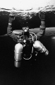 Tech diver with 2 stage tanks under the ice in Morrison's Quarry. Nikonos V, 12mm Sea & Sea lens, AGFA 100 ASA B&W film, manual exposure with Ikelite 150 strobe fill. Scratches removed in PS. 