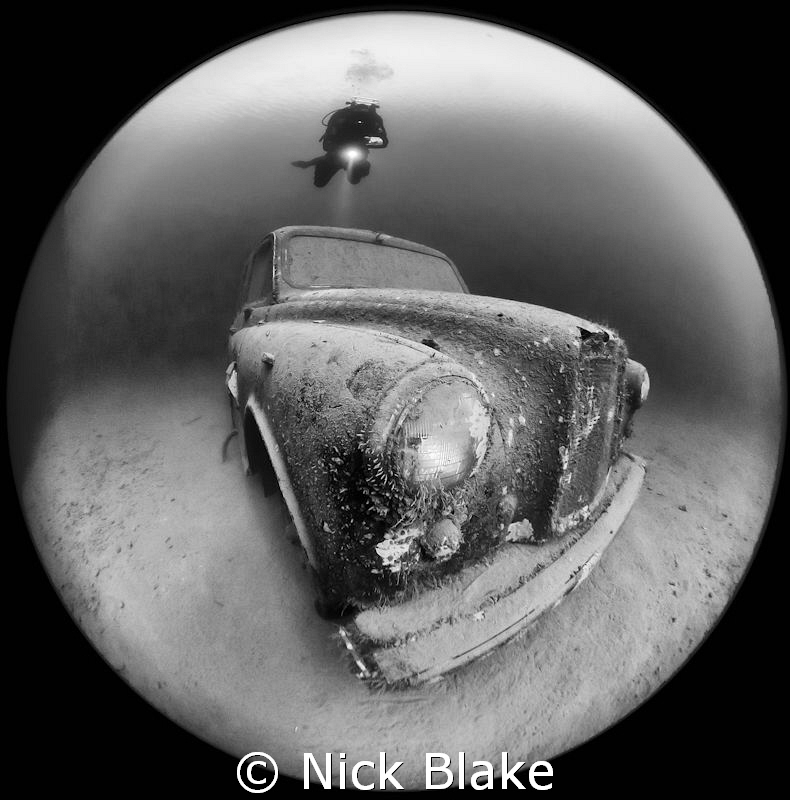 Wraysbury Lake's London Taxi Cab and Diver, taken with a Sigma Circular fish eye. Black & white conversion 