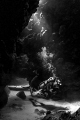 Light filters onto a diver as he emerges from a swim through on Grand Cayman. Light filters onto a diver as he emerges from a swim through on Grand Cayman.