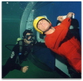 Helicopter Underwater Escape Training (HUET) is vital training for offshore oilrig workers who may face the situation where they may have to escape from a submerged helicopter to survive. Photo shows helo 'pilot' carrying out short free ascent.