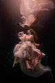 This underwater portrait of a beautiful woman was taken in my pool in Florida. She's a dear friend of mine and is one of my muses. We used natural light, a fine art backdrop, and a gown by Katharina Hakaj to complete the look.