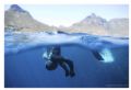A freediver prepares to dive off Cape Town, with Lion's Head and Table Mountain in the background. Very flat sea, Nikon D200 with 28mm lens