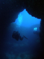 A diver going through Cirkewwa Arch on Malta's north west coast