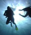 A helping hand. Local Scuba Instructor assists first time diver near Ochos Rios, Jamaica.