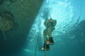 Italian Navy Hard hat diver, ascendig to the surface after a work session on the muddy sea bed.