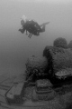 Diver swims over one of two locomotives at bottom of Sherkston Quarry near Lake Erie.