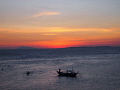 Beautiful sunset after a day if diving in Anilao, dive boats just being moored for the night.
