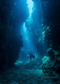 Diver navigating a passage between the reefs