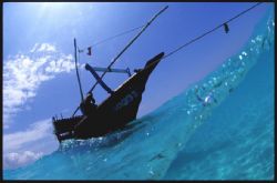 This dhow was anchored just in the surf off a sandbank, Z... by Andrew Woodburn 