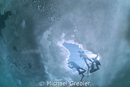 Looking up at free divers getting ready to dive from the ... by Michael Grebler 