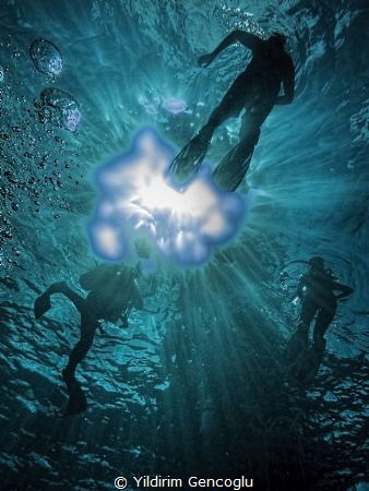 Divers towards the sun. by Yildirim Gencoglu 