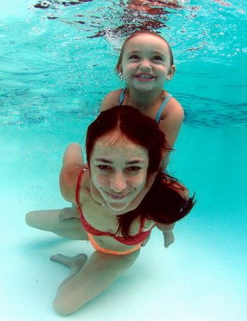 mother and child enjoy the warm pool water. relaxed. take... by Fiona Ayerst 