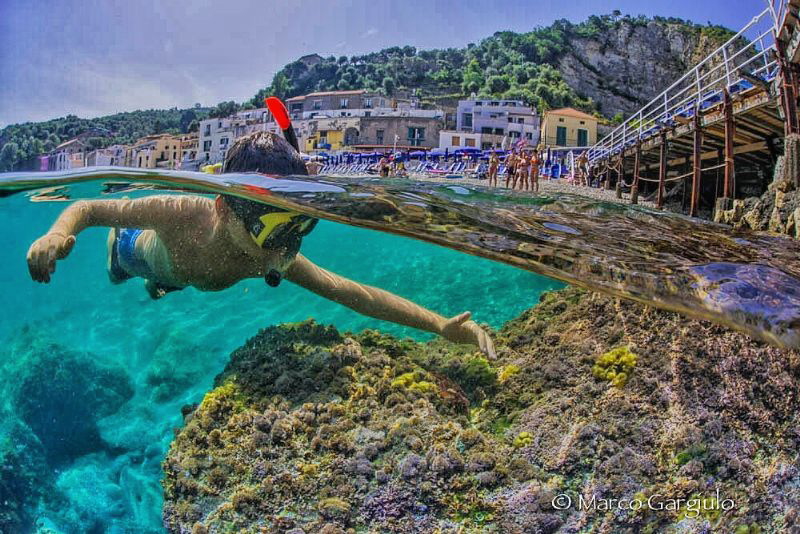 a boy and a crab by Marco Gargiulo 