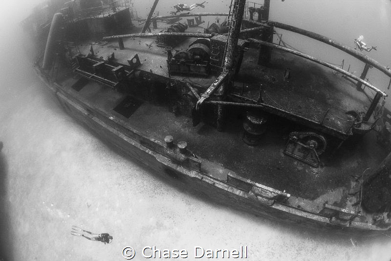 "Explore"
Divers exploring the Kittiwake in Grand Cayman. by Chase Darnell 