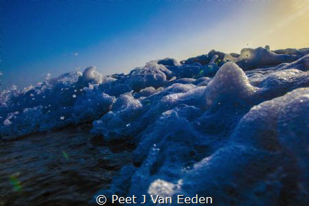 The last rays of  sunset transformed into a rainbow by Peet J Van Eeden 