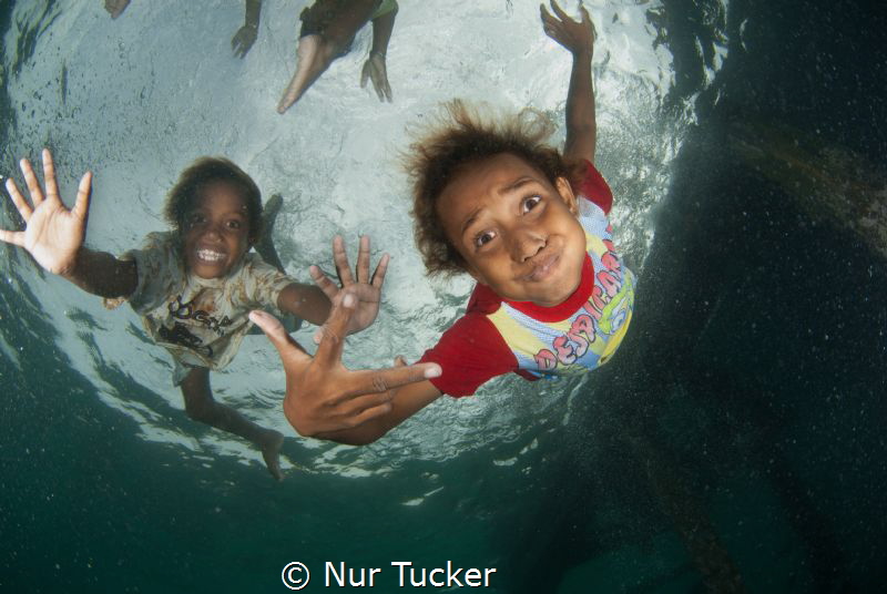 Local children of the Arborek Jetty by Nur Tucker 