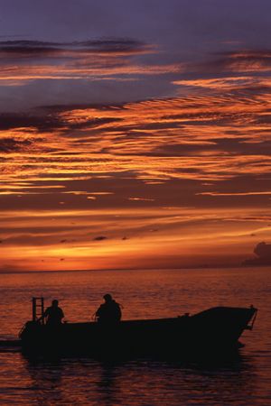Diver returning from dusk dive. by Richard Smith 