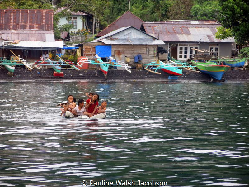 Children of Tandurusa Village playing on a makeshift raft... by Pauline Walsh Jacobson 