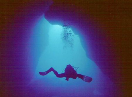 A buddy of mine exiting the grotto to the Phillipine Sea ... by Scott Kreger 