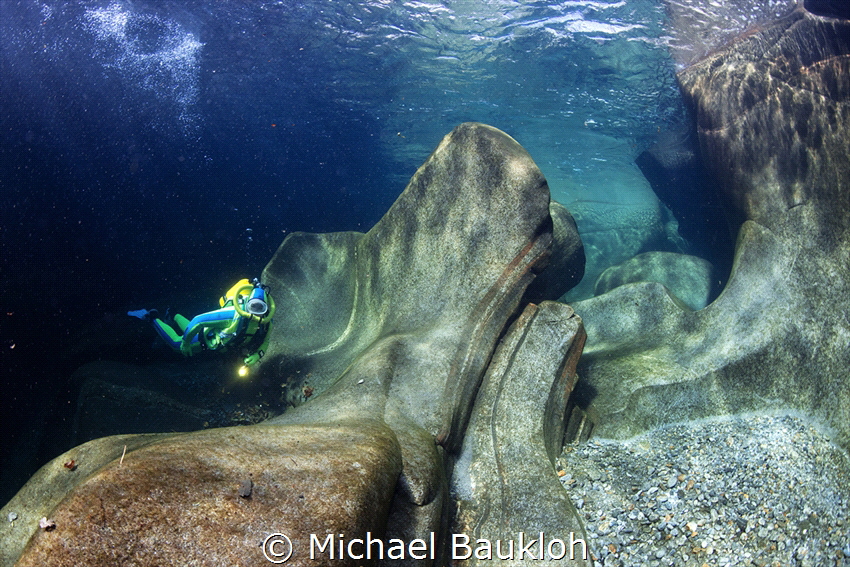 Diving in the River Verzasca. Switzerland by Michael Baukloh 