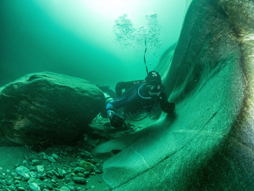 Riverdiving in the Verzasca river in Switzerland. by Brenda De Vries 